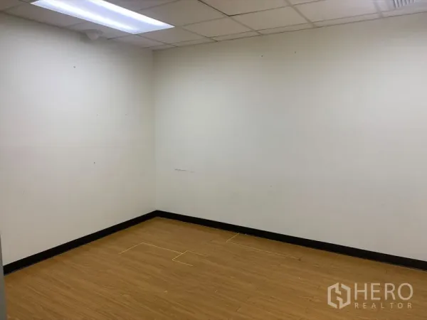 办公空间 出租在Bang Rak, Bangkok - 小型独立办公室，木纹地板与白色墙面，荧光灯照明。