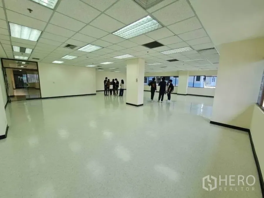 Office Space for rent in Watthana, Bangkok - Spacious open-plan office with grid ceiling lights, glossy floors and wide windows providing natural light.