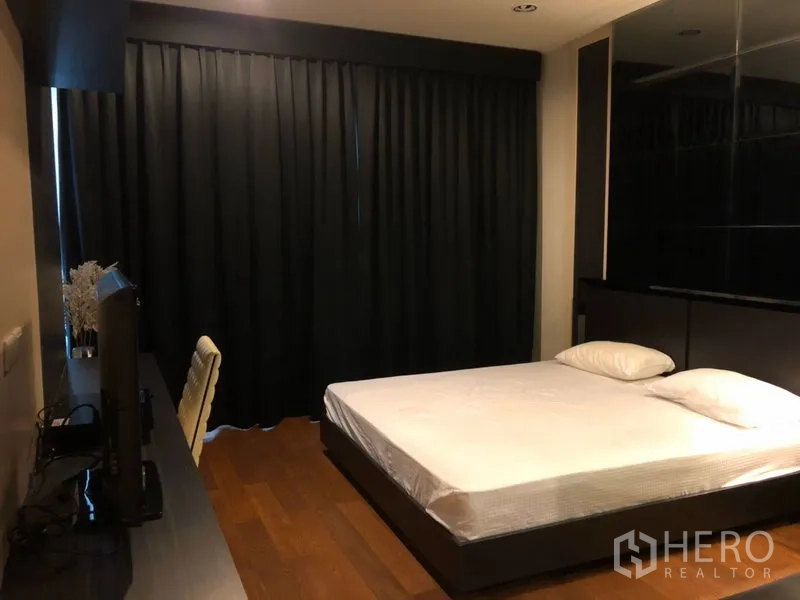 คอนโด ให้เช่าในPathum Wan, Bangkok - ห้องนอนรอง เตียงขนาดควีน ผ้าม่านทึบ แผงทีวี และพื้นไม้