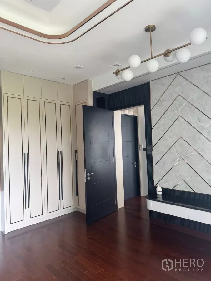 บ้าน ให้เช่าในLat Krabang, Bangkok - มุมห้องนอนพร้อมตู้บิลท์อิน ผนังตกแต่ง และโคมไฟโมเดิร์น