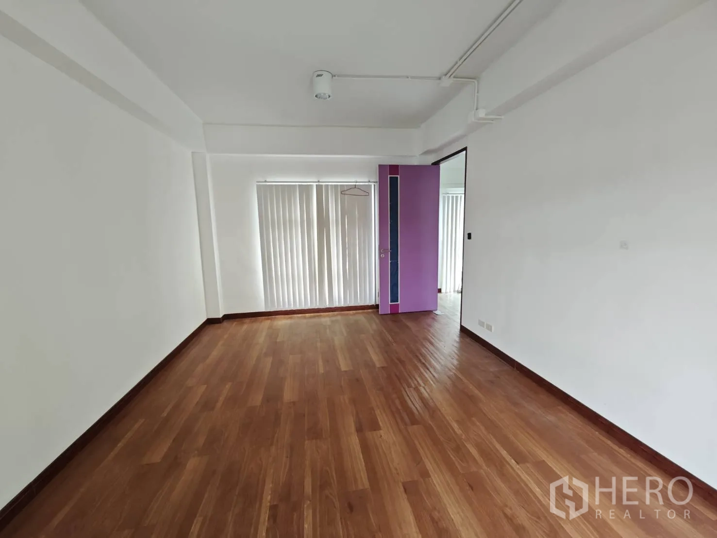 Office Space for rent in Prawet, Bangkok - Private office room with timber floors, white walls and a purple door.