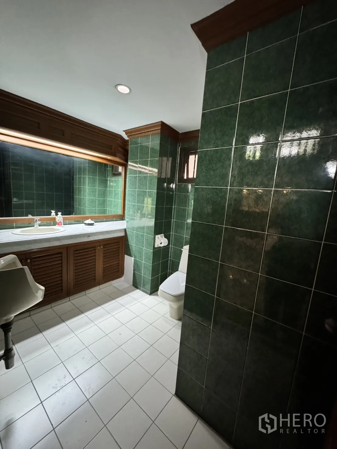 Home Office for rent in Watthana, Bangkok - Townhouse-style exterior with balconies and roller shutters along an urban lane.