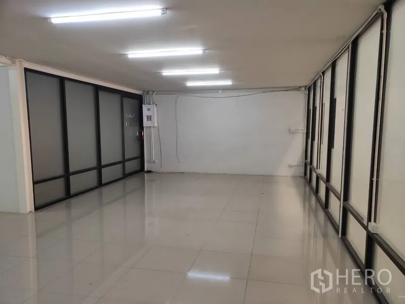 Home Office for rent in Pathum Thani - Flexible office space lined with floor-to-ceiling frosted glass panels and tile flooring.