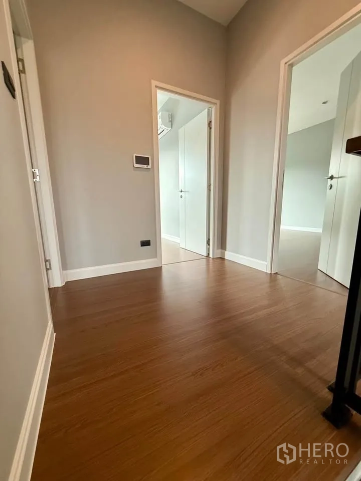 Detached House for rent in Don Mueang, Bangkok - Upstairs landing and hallway with wood flooring and doors to rooms.