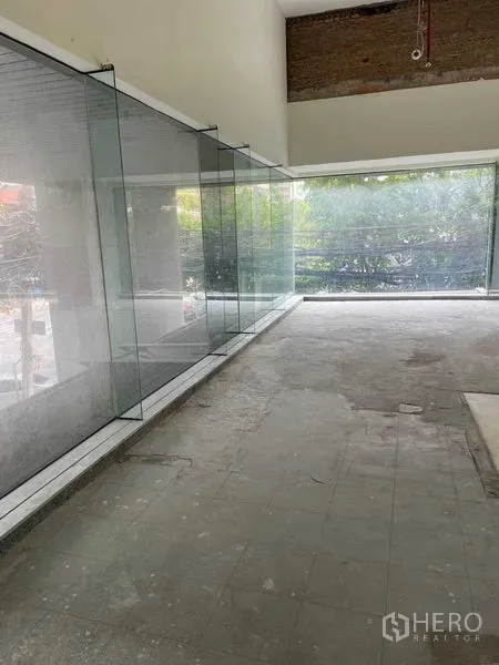 Office Space for rent in Watthana, Bangkok - Open-plan office shell with floor-to-ceiling windows bringing natural light and leafy views.