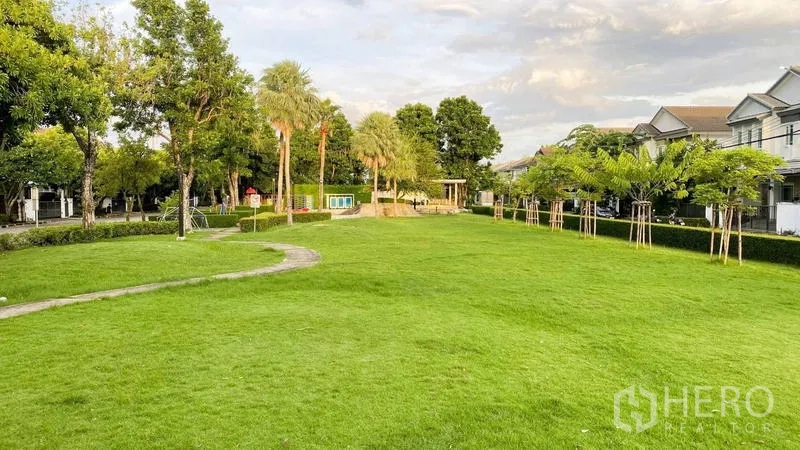 Detached House for rent in Bang Kapi, Bangkok - Green community park with wide lawn, pathway and surrounding homes.