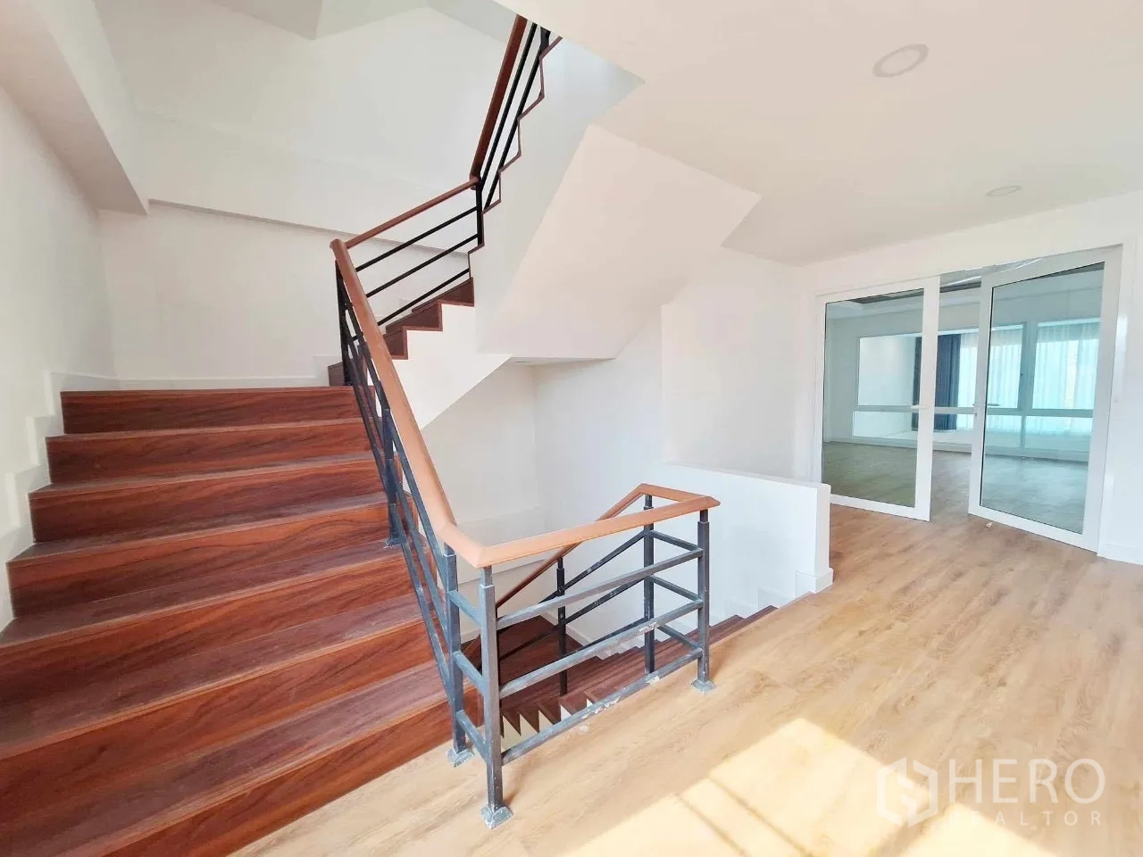 Home Office for sale in Bueng Kum, Bangkok - Wide staircase with wood treads and metal railings connecting all levels.
