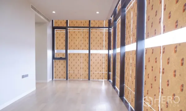 คอนโด ขายในWatthana, Bangkok - พื้นที่นั่งเล่นกว้างพื้นไม้โทนอ่อน พร้อมหน้าต่างแบบเต็มผนังปิดป้องกันระหว่างปรับปรุง