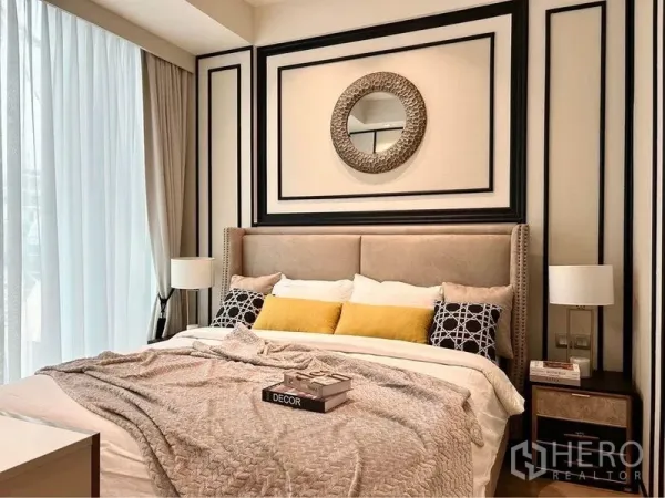Condominium for rent in Pathum Wan, Bangkok - Cozy master bedroom with upholstered headboard, layered pillows, bedside tables and full-height curtains.