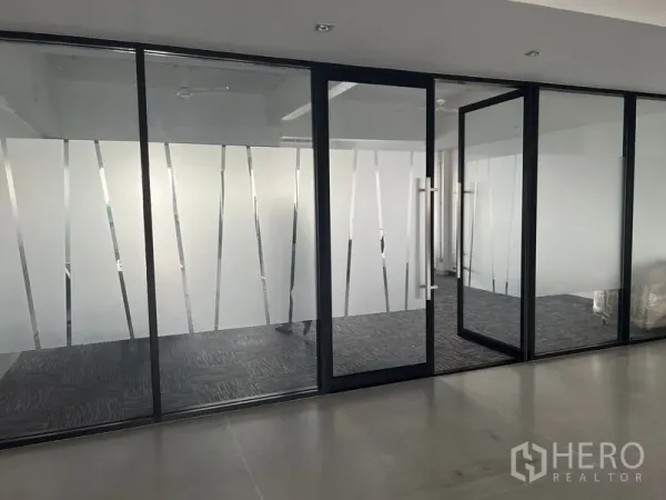 Office Space for rent in Mueang Samut Prakan, Samut Prakan - Frosted glass office frontage with black frame and an open door.