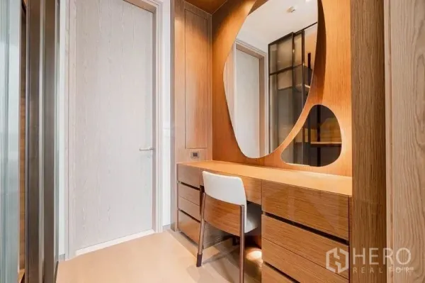 Condominium for rent - Wood-clad dressing area with built-in vanity and sculptural mirror.
