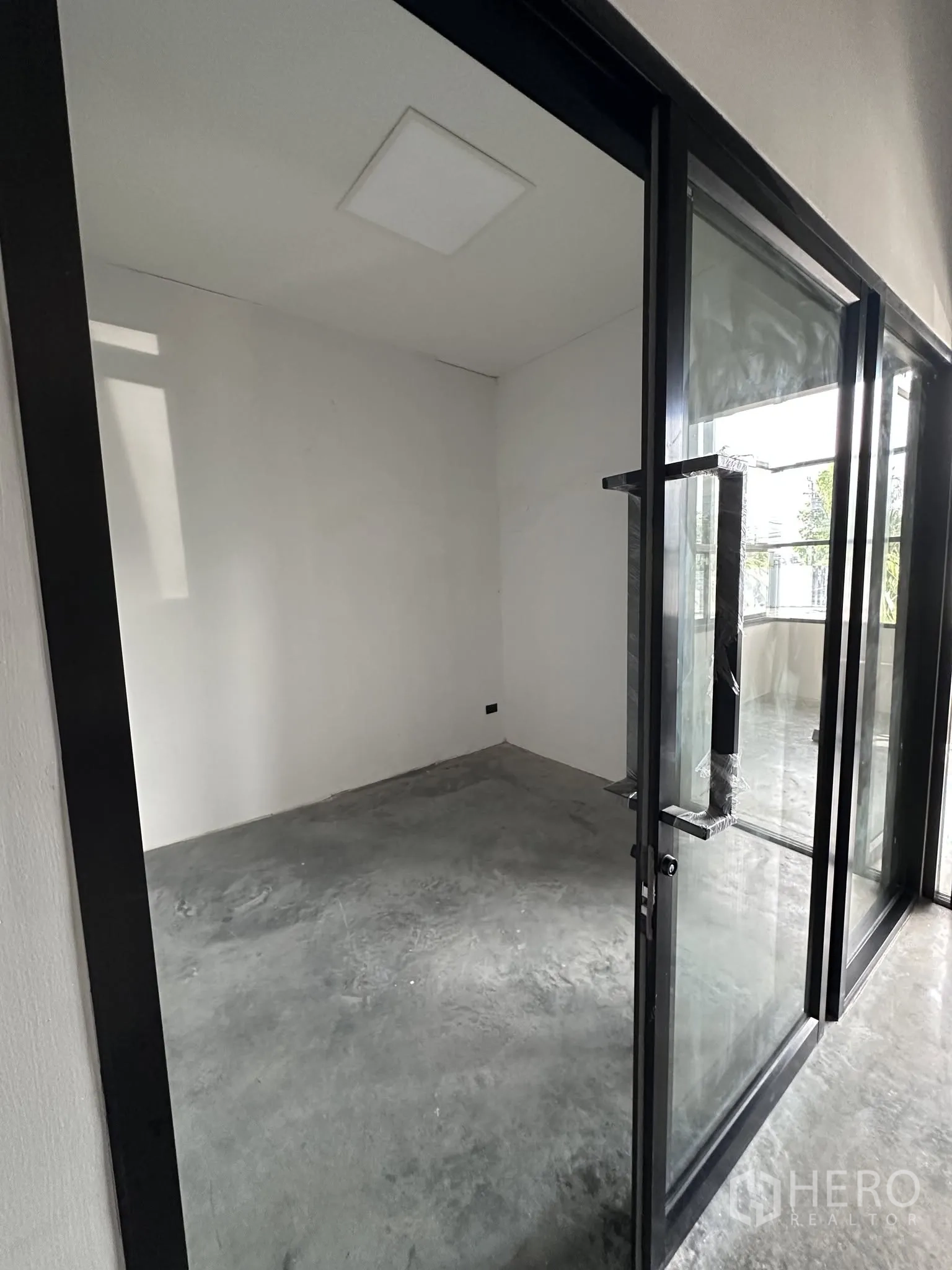 Warehouse for rent or sale in Prawet, Bangkok - Small glass-enclosed office opening off the main warehouse floor.