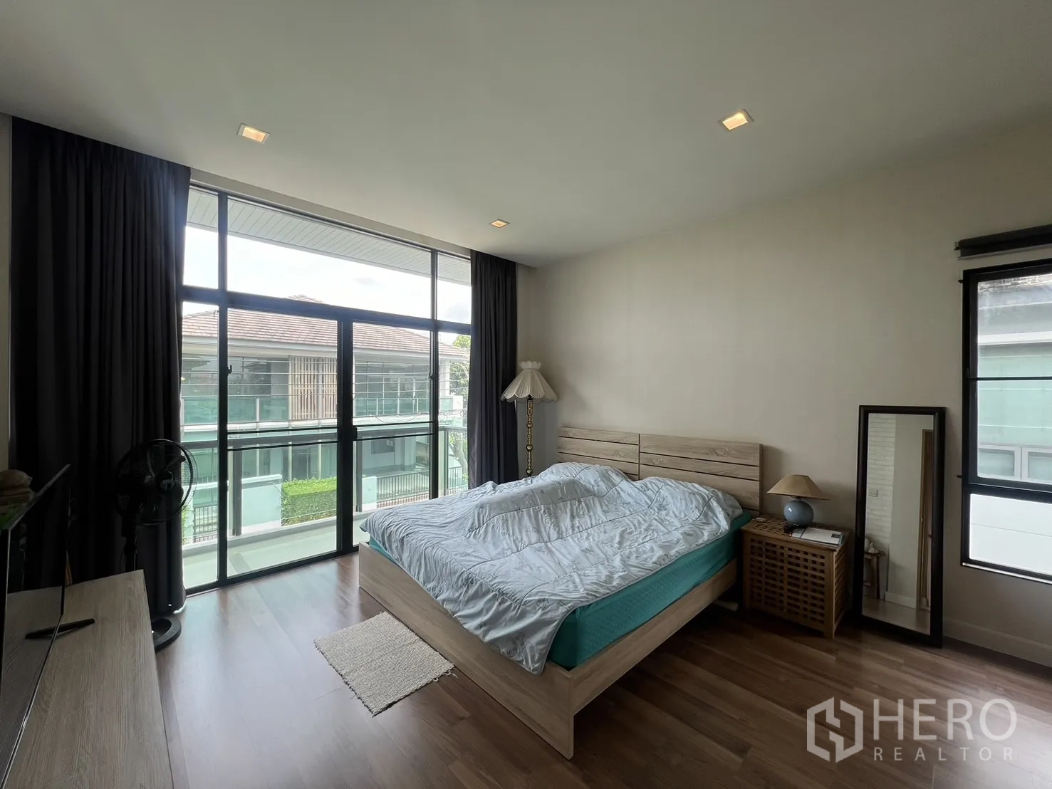 Detached House for rent in Bang Kapi, Bangkok - Master bedroom with sliding glass door to balcony and garden views.