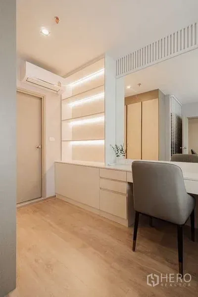 Condominium for rent - Built-in vanity desk with backlit shelving and wood flooring in the bedroom area.
