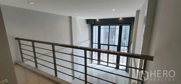 Home Office for rent - Mezzanine level with metal railing overlooking a bright double-height lobby.