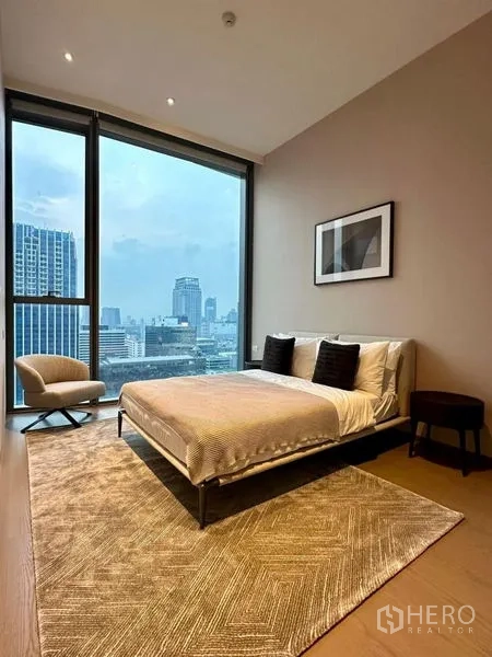 Condominium for rent or sale - Bright bedroom with floor-to-ceiling windows and panoramic city view.