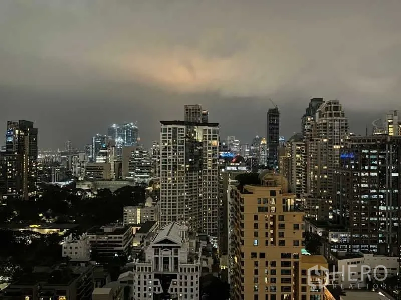 Condominium for rent or sale - High-floor night view of Bangkok skyline over the Lumphini area.