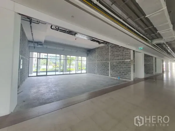 零售空间 出租在Bang Khun Thian, Bangkok - 毛坯零售铺面，混凝土地面，外露天花，整面落地玻璃，面向景观广场。