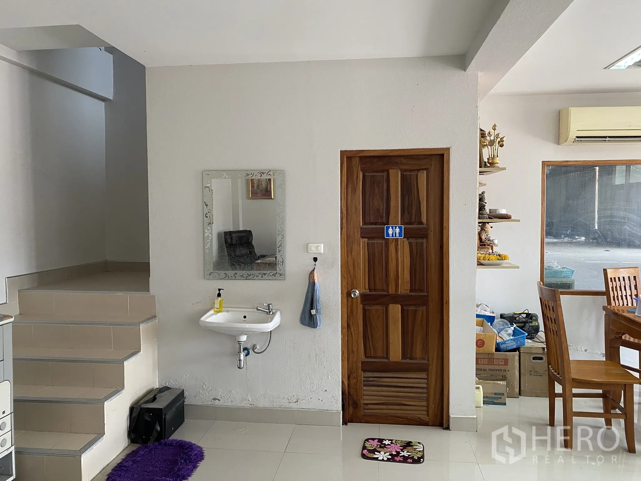 Factory for sale in Mueang Chon Buri, Chon Buri - Office interior with staircase, wooden door and wall-mounted sink near dining set.