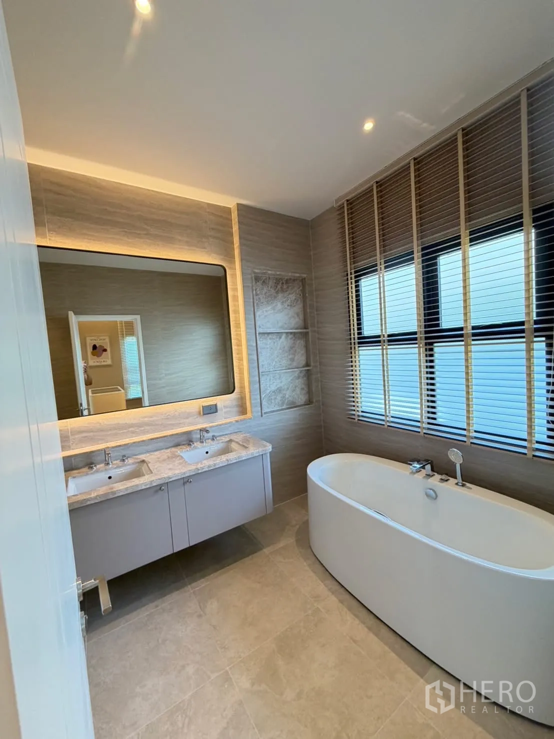 Detached House for rent in Saphan Sung, Bangkok - Stylish bathroom with freestanding soaking tub, double vanity, and window blinds.
