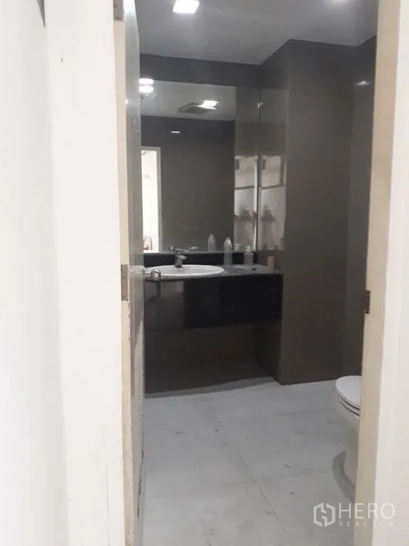 零售空间 出租在Watthana, Bangkok - 店内现代化卫生间，设洗手盆、镜子与坐便器。