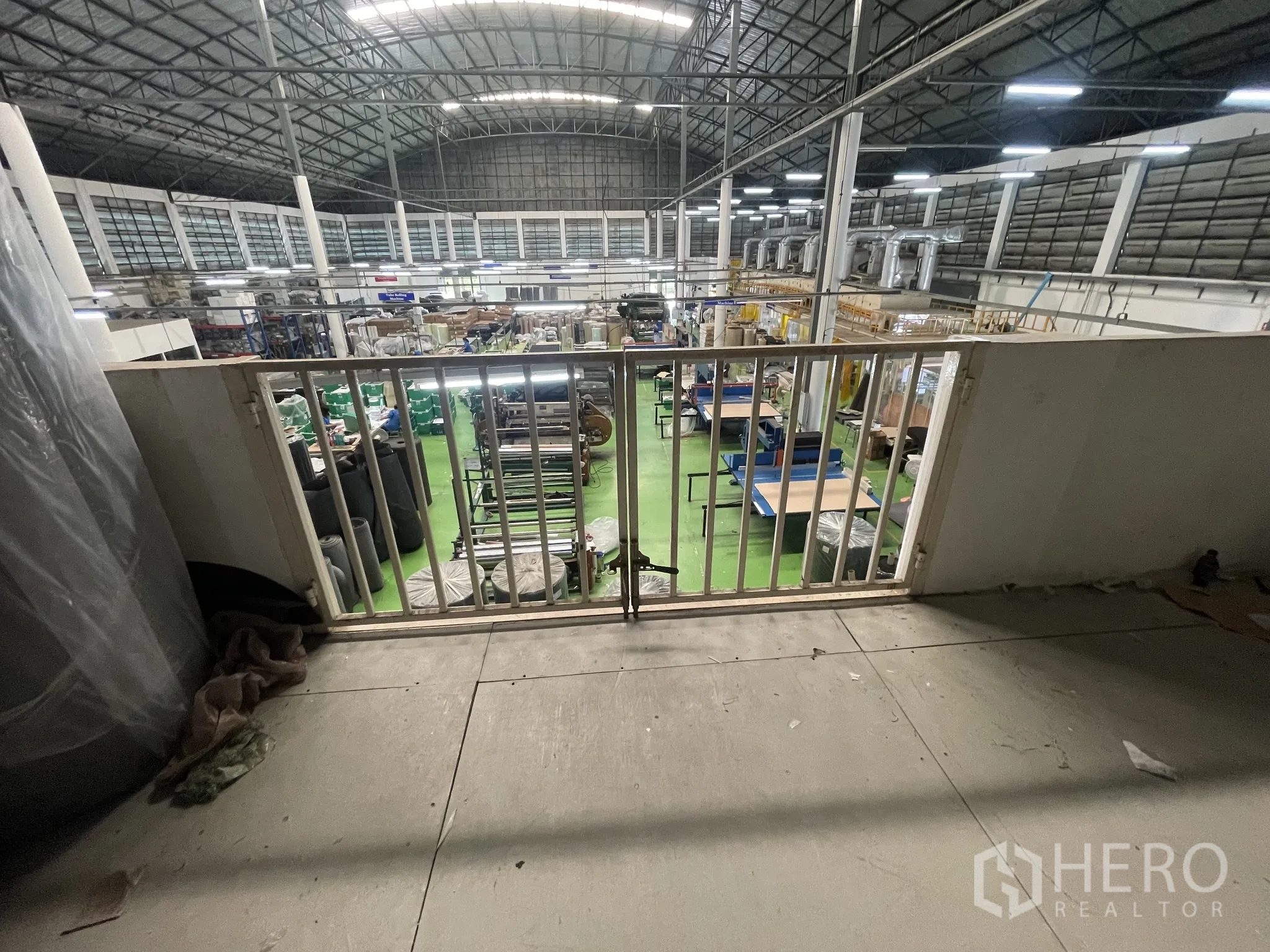Warehouse for sale in Lat Lum Kaeo, Pathum Thani - Mezzanine platform with safety railing overlooking the manufacturing floor.