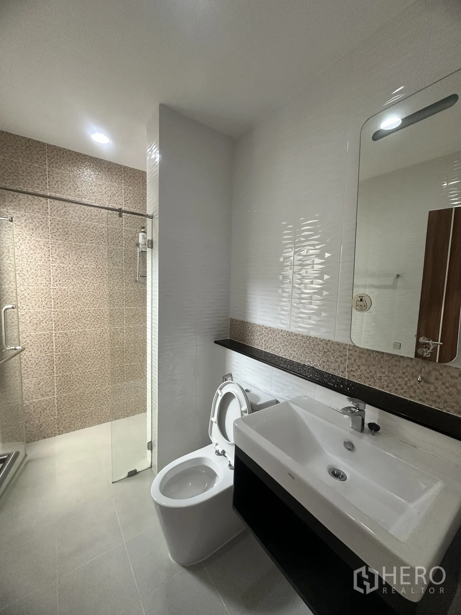 Detached House for sale in Pak Kret, Nonthaburi - Bathroom with glass shower enclosure, vanity, and toilet.