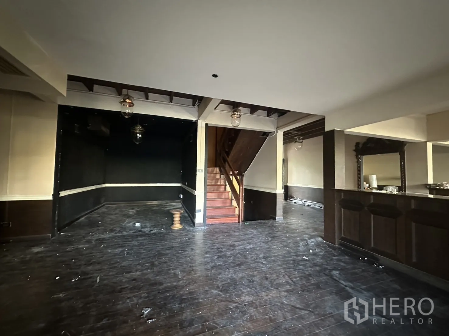 Detached House for rent - Staircase rising from open lounge next to a wooden service counter.