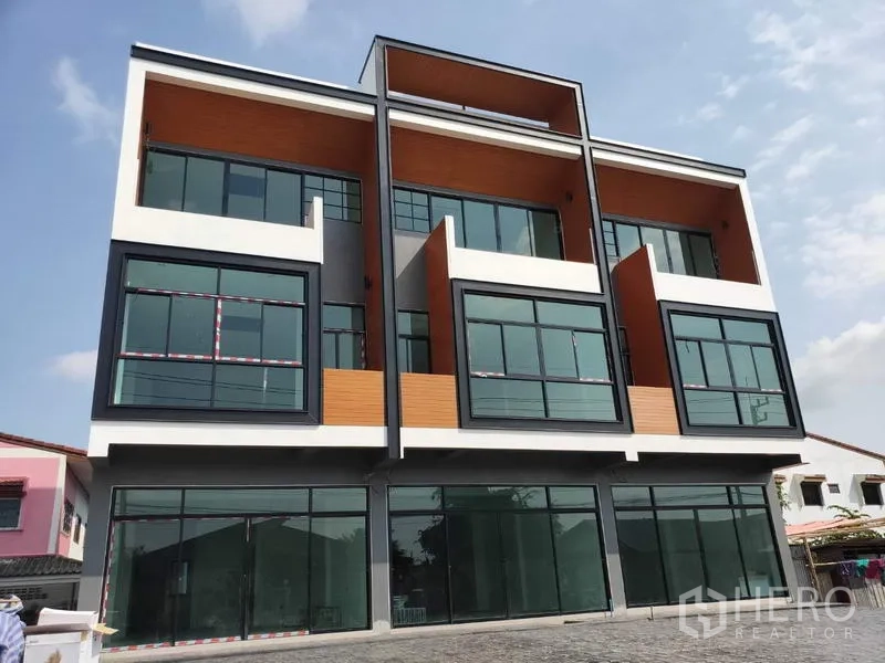 Home Office for sale in Lam Luk Ka, Pathum Thani - Front elevation of a contemporary home office building with floor-to-ceiling windows.