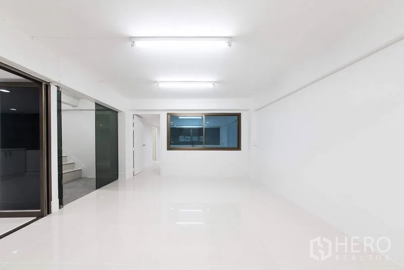 Home Office for sale in Bang Kho Laem, Bangkok - White room with sliding glass doors, window and access to staircase landing.