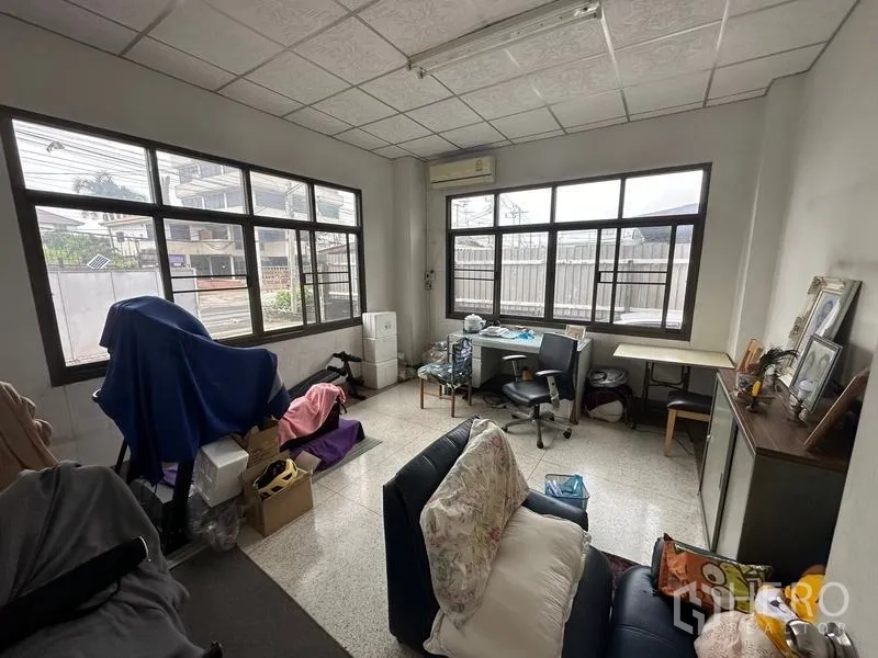 Home Office for sale in Phra Pradaeng, Samut Prakan - Ground-floor office room with large windows, desks and an air conditioner.
