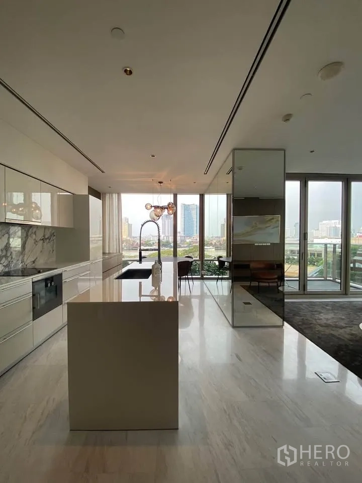 Condominium for rent in Sathon, Bangkok - Contemporary kitchen with a marble island, built-in oven, and city views.