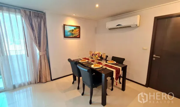 อพาร์ทเมนท์ ให้เช่าในWatthana, Bangkok - มุมทานอาหารสำหรับสี่ที่นั่ง มีงานศิลป์ แอร์ และผ้าม่านสูงจรดเพดานติดกับระเบียง