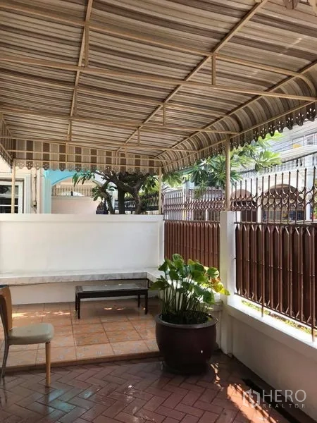 Detached House for rent in Khlong Toei, Bangkok - Covered front terrace with striped awning, iron fence and seating area