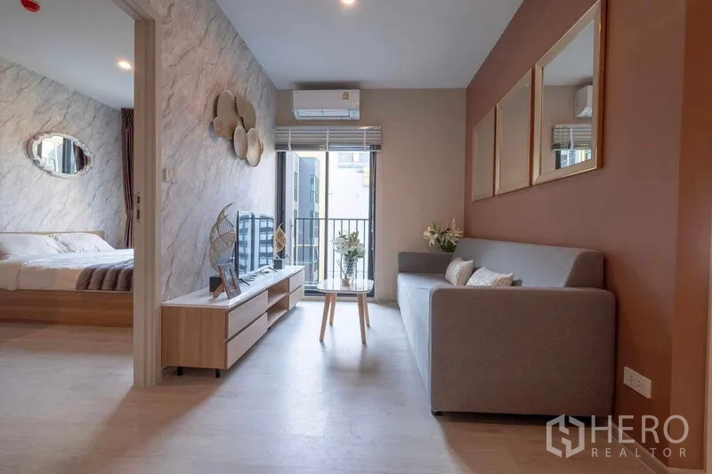 คอนโด ให้เช่าในBang Na, Bangkok - ห้องนั่งเล่นมีโซฟา ประตูบานเลื่อนออกระเบียง และห้องนอนติดกัน