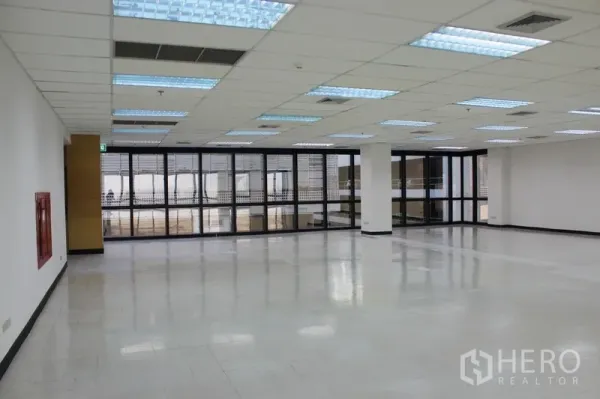 สำนักงาน ให้เช่าในWatthana, Bangkok - พื้นที่ทำงานเปิดโล่ง ไฟฟลูออเรสเซนต์ หน้าต่างกรอบดำ และตู้ดับเพลิงติดผนัง