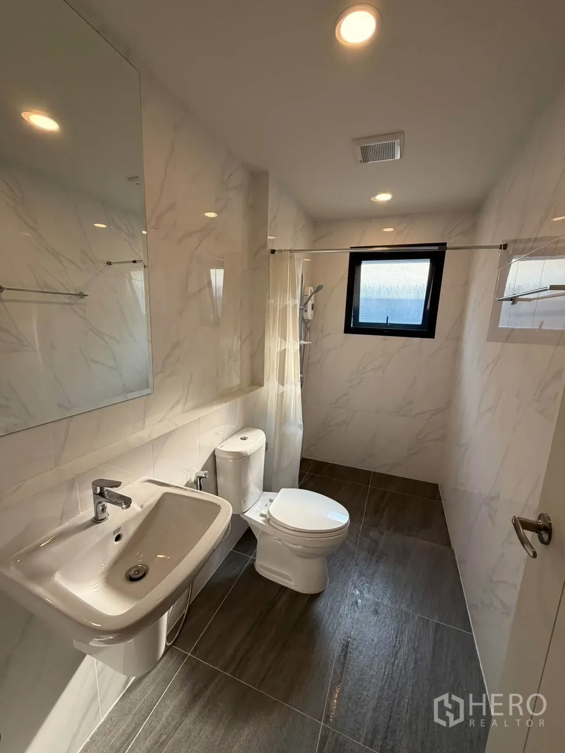 บ้านเดี่ยว for rent in Bang Phli, Samut Prakan - ห้องน้ำสว่างมีอ่างล้างหน้า กระจกบานใหญ่ โถสุขภัณฑ์ และโซนอาบน้ำ.