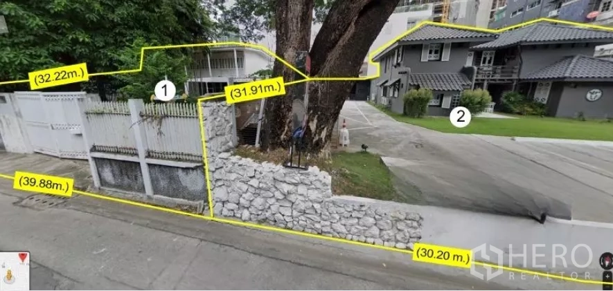 Land for sale - Gated entrance with stone wall, large tree and two-storey house on the plot, with dimension labels overlaid.