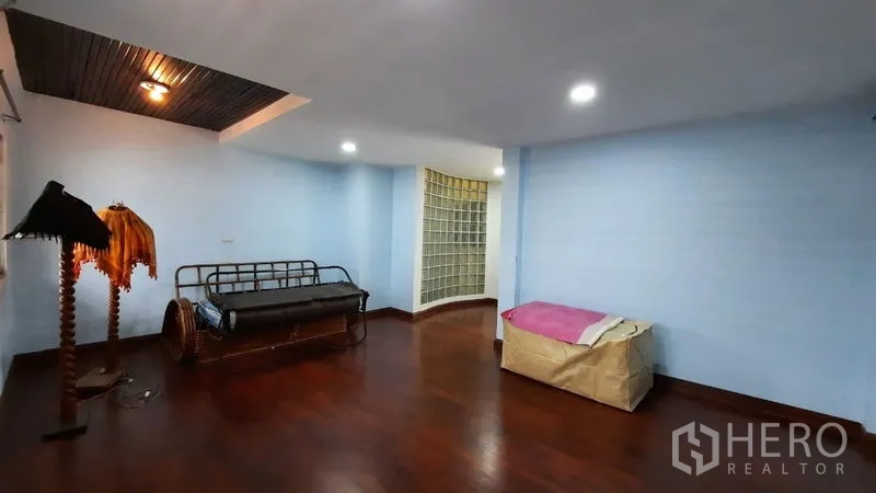 ทาวน์เฮาส์ ให้เช่าหรือขายในSuan Luang, Bangkok - ห้องนั่งเล่นกว้าง พื้นไม้ ผนังสีฟ้า เพดานฝ้าซ่อนไฟ