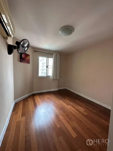 公寓 出租或出售在Yan Nawa, Bangkok - 次卧木地板，带窗与壁挂风扇。