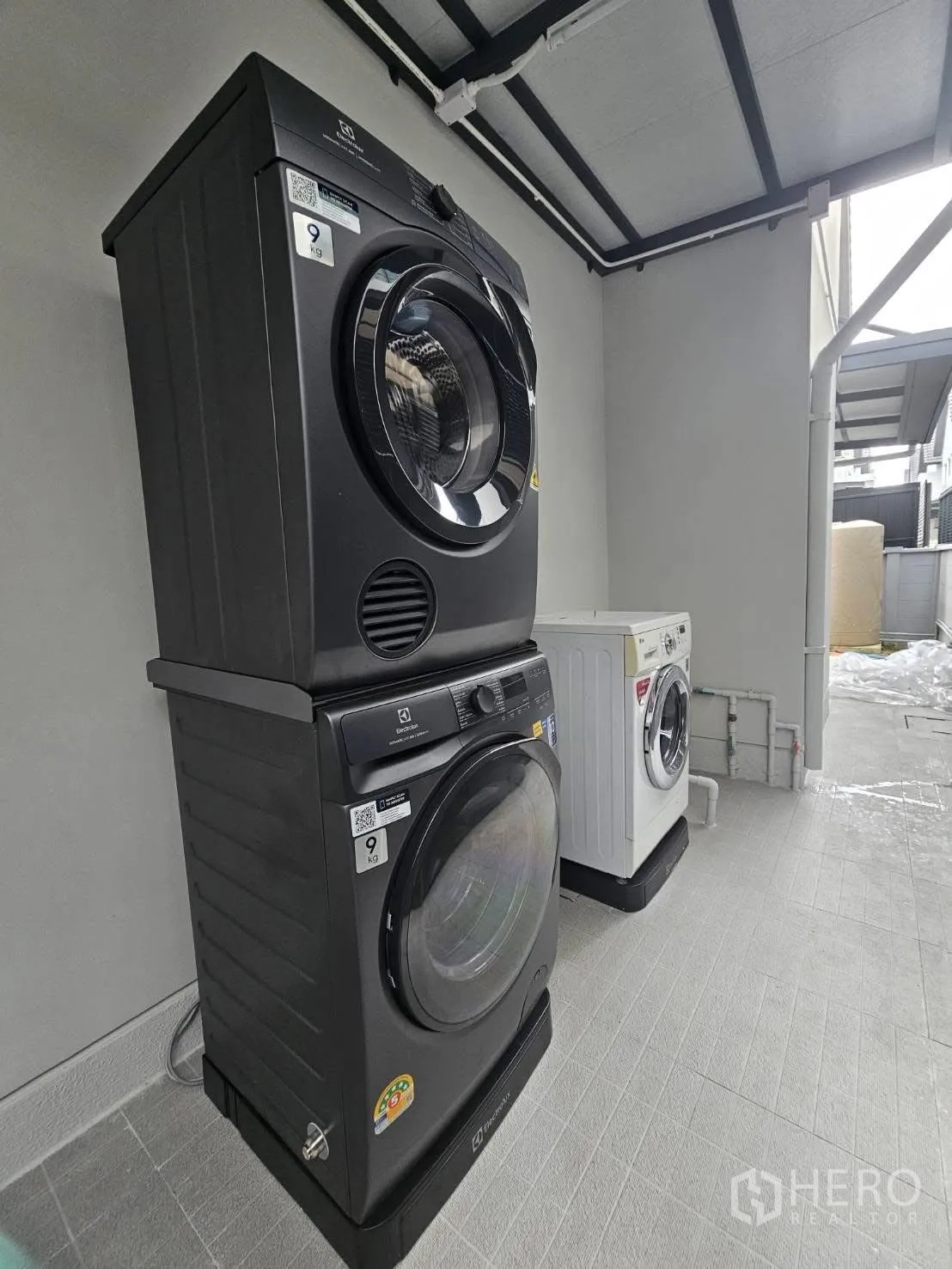 独栋房屋 for rent or sale in Bang Phli, Samut Prakan - 叠放式前开门洗烘设备置于半户外空间。