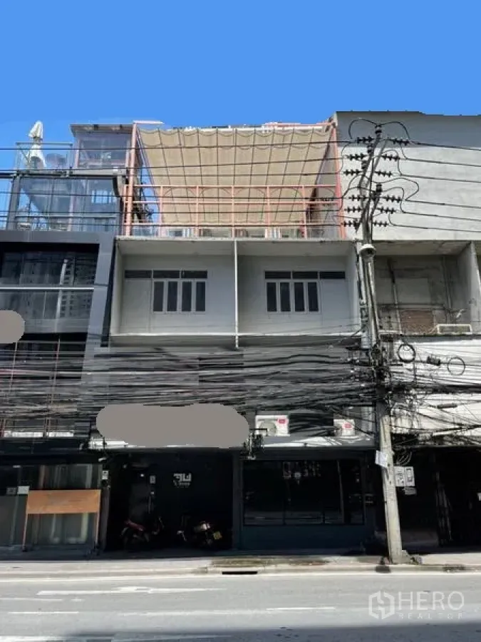 店屋 出租或出售在Watthana, Bangkok - 临街多层商铺外立面，带阳台与架空线缆