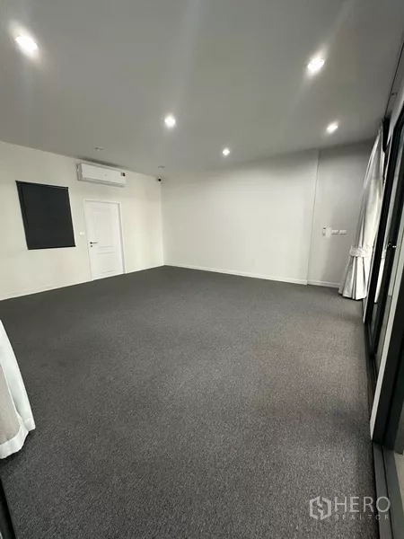 Home Office for rent - Carpeted room with split air-conditioner, recessed lights and a side door.