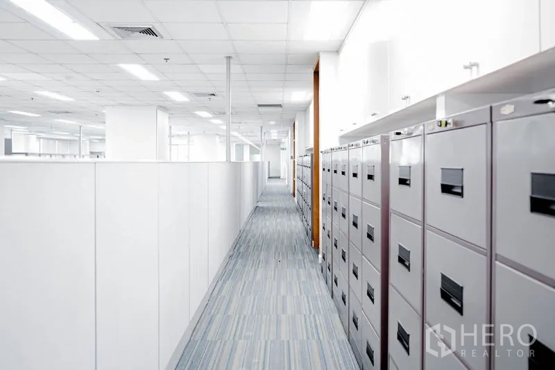 Office Space for rent in Watthana, Bangkok - Hallway lined with filing cabinets beside the open office area.