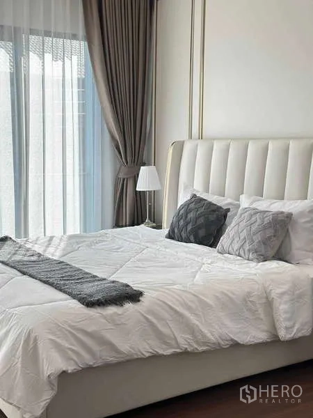 Detached House for rent or sale in Bang Phli, Samut Prakan - Guest bedroom with padded headboard, sheer curtains and grey accent pillows.