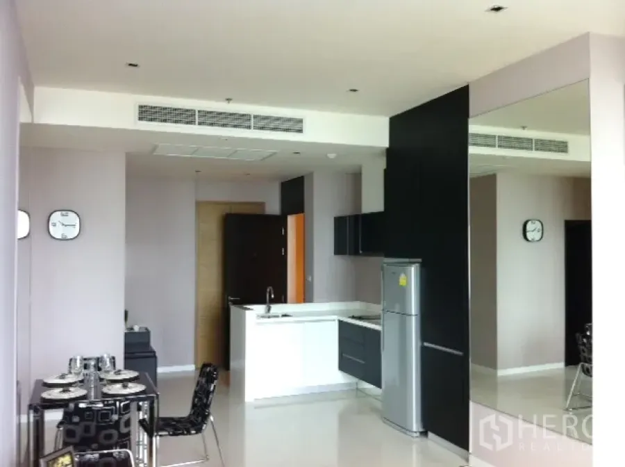 คอนโด ให้เช่าในWatthana, Bangkok - คอนโดแปลนเปิด ครัวไอส์แลนด์สีขาว ตู้สีดำ มุมทานอาหาร และผนังกระจกเงา