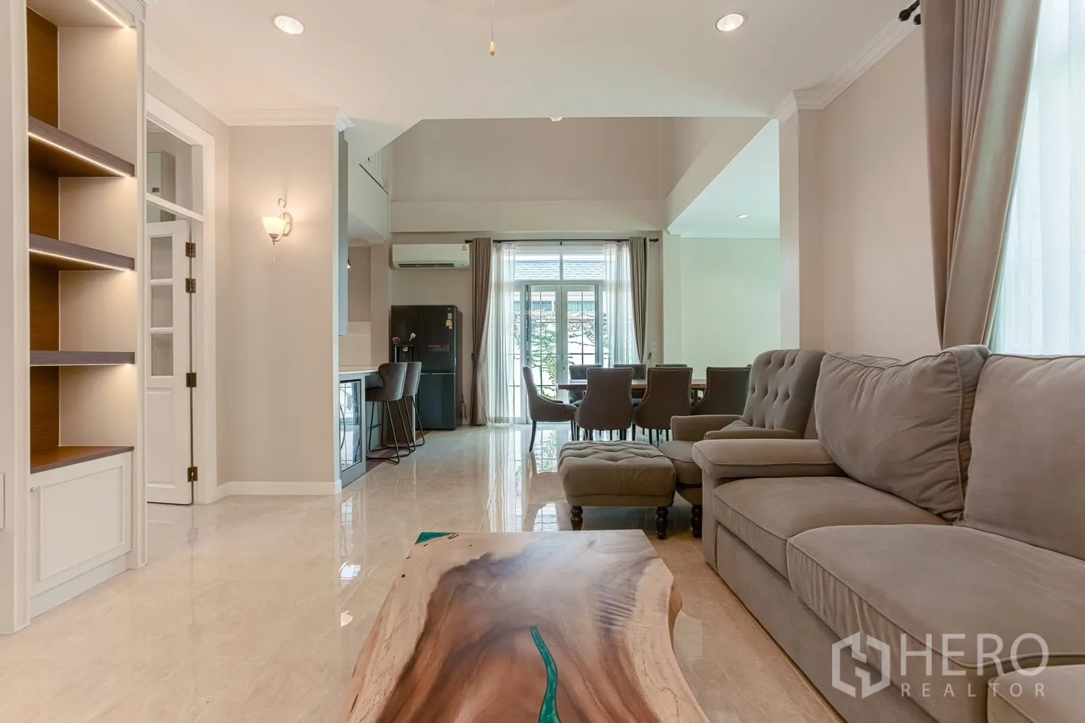 Detached House for rent in Bang Na, Bangkok - Cozy living area view with live-edge coffee table and soft gray sofa.