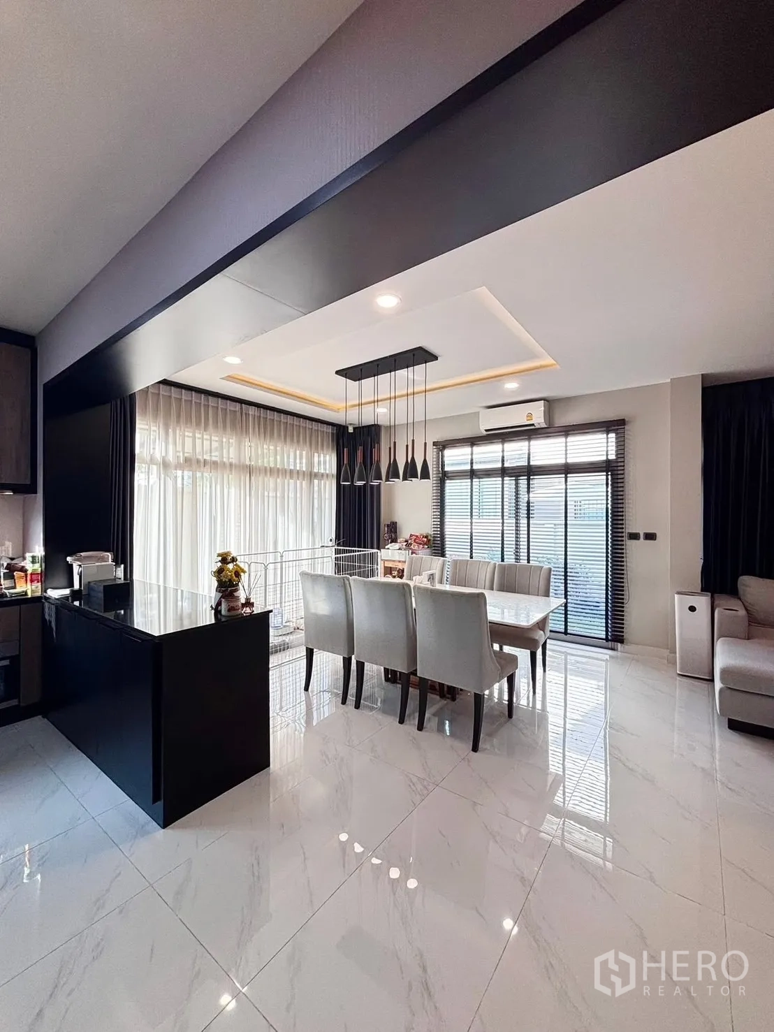 Detached House for rent in Bang Phli, Samut Prakan - Living room with sofa set facing double front doors and garden views.