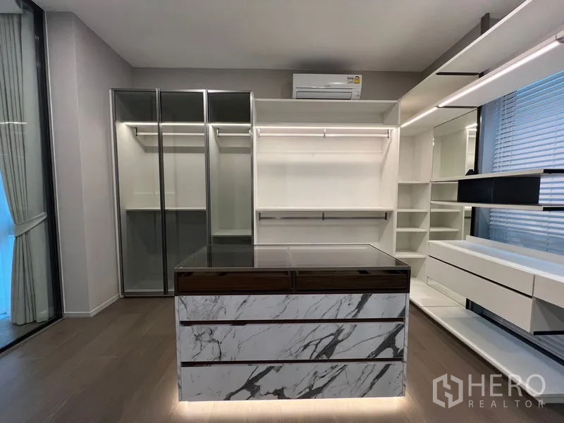 Detached House for sale in Saphan Sung, Bangkok - Another angle of the custom walk-in closet with illuminated shelving and marble island.