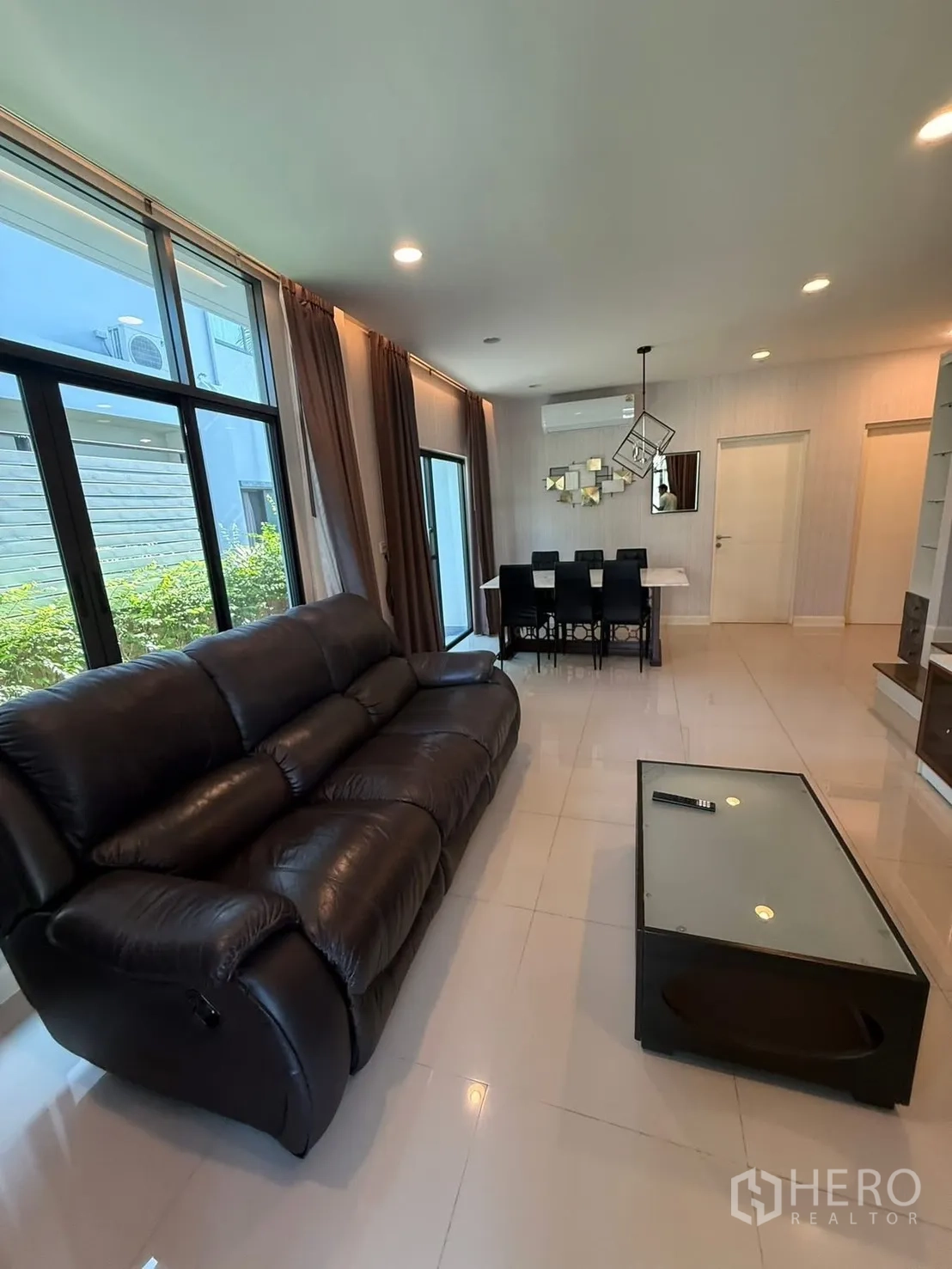 Detached House for rent in Prawet, Bangkok - Open-plan living and dining area with large windows and garden views.